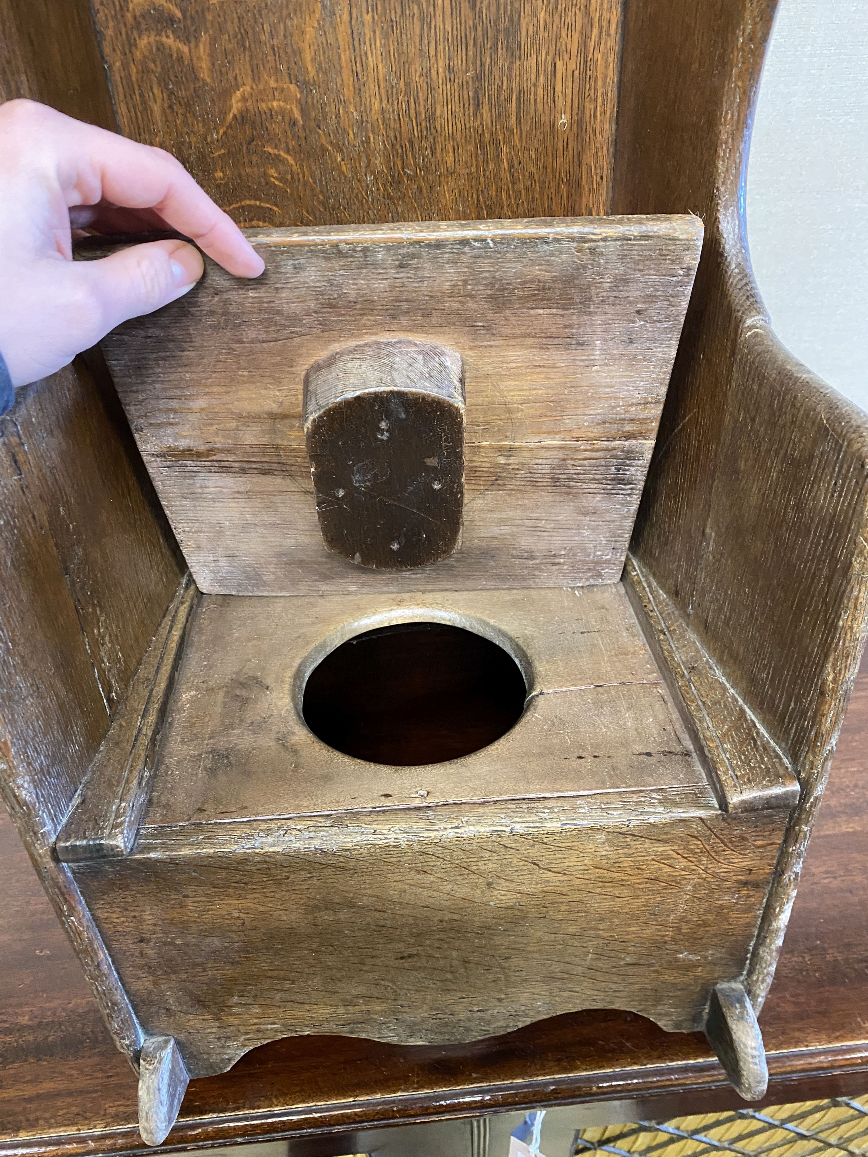 An 18th century oak child's rocking commode chair, width 33cm, depth 50cm, height 70cm